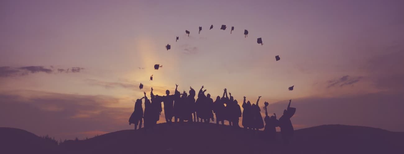 Students throwing graduation caps in the air